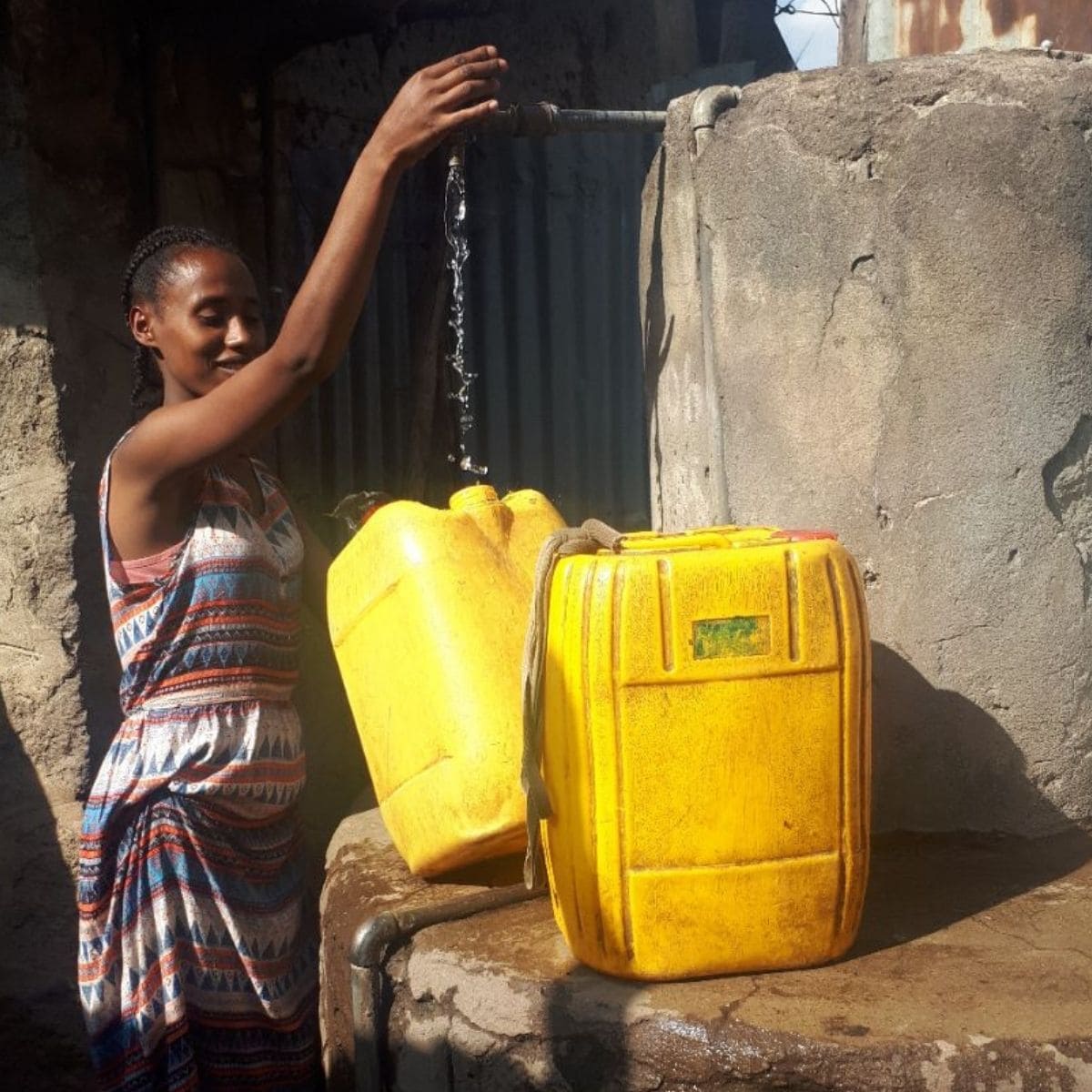 student with fresh water in Ethiopia