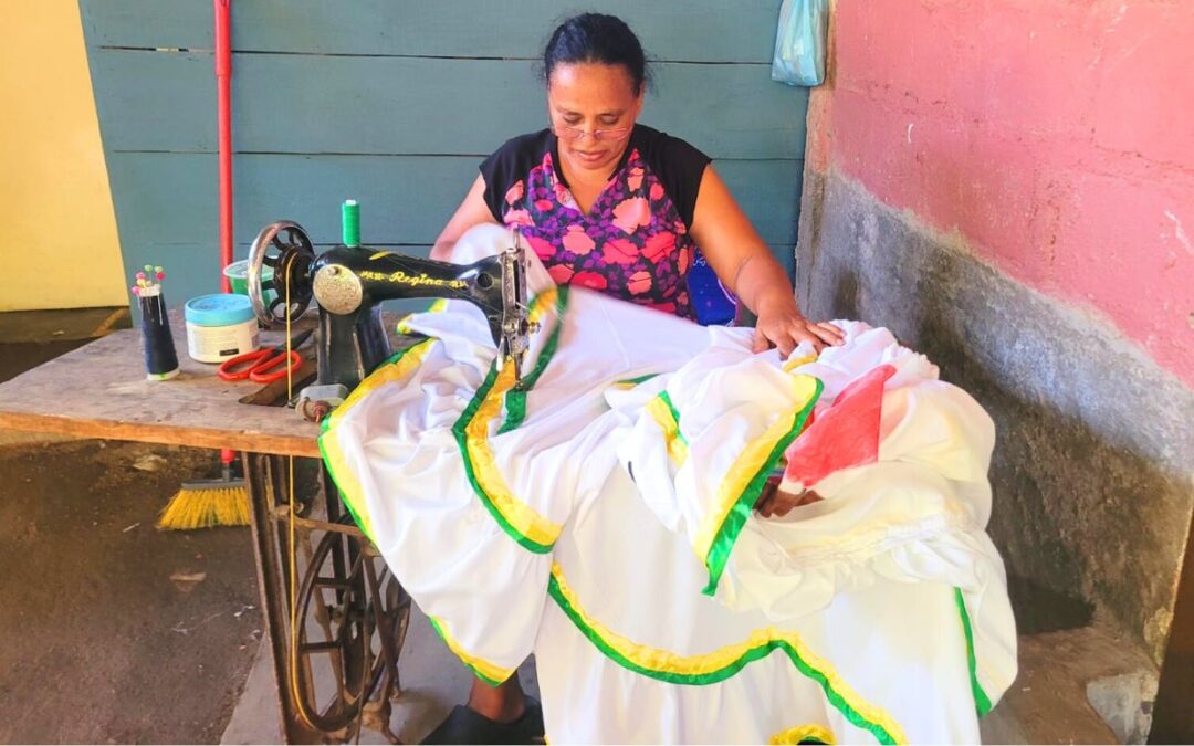 Lorena sewing a dress with an antique sewing machine