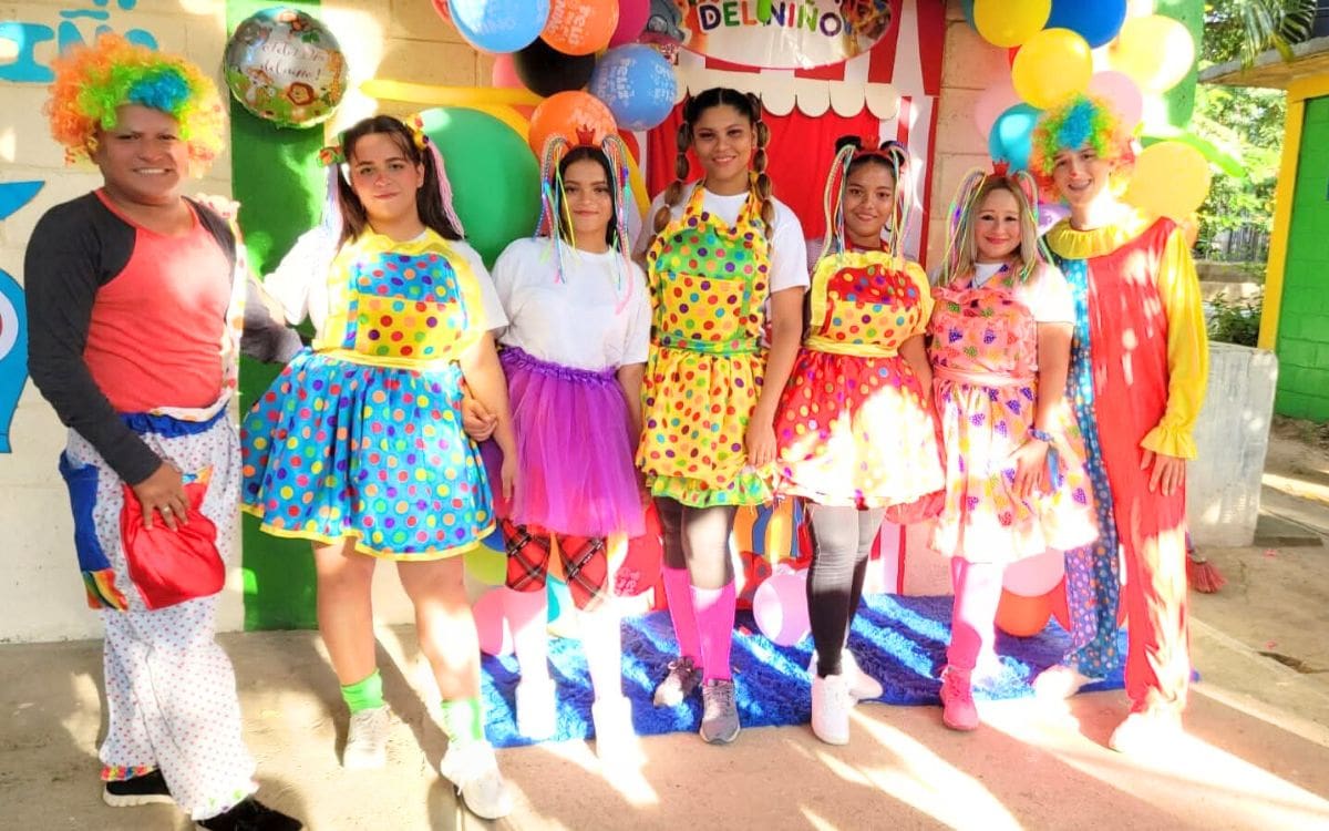 International Samaritan volunteer and team members in Honduras with clown costumes for Children's Day.