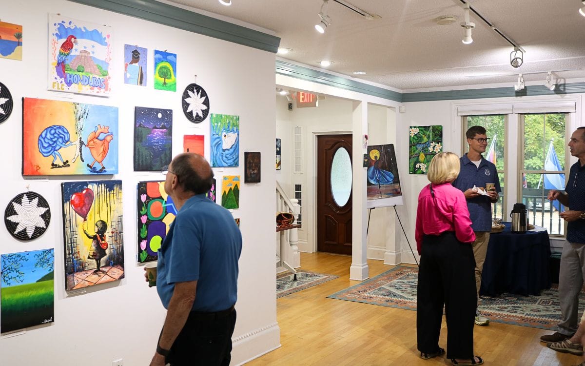 Members of the Ann Arbor community viewing the artwork at International Samaritan's offices.