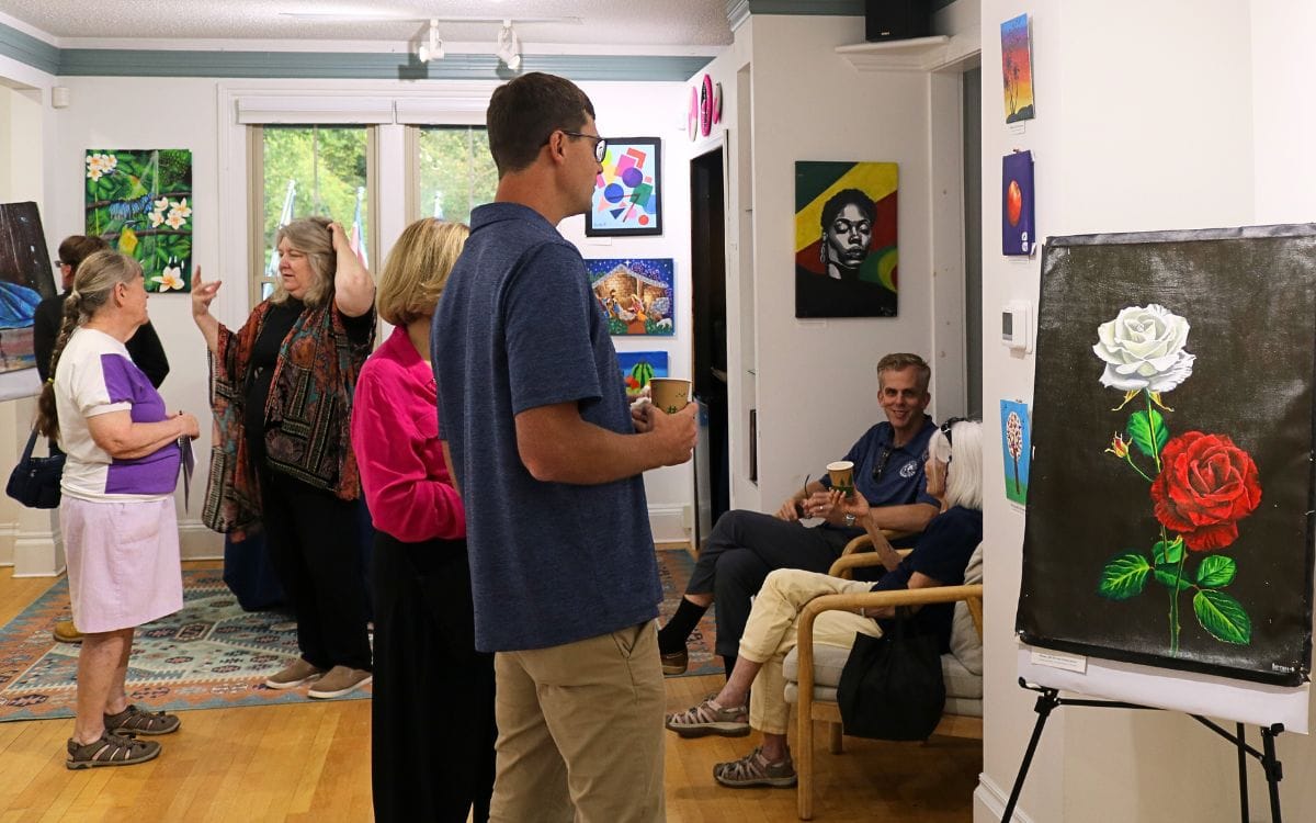 Members of the Ann Arbor community viewing the artwork at International Samaritan's offices.