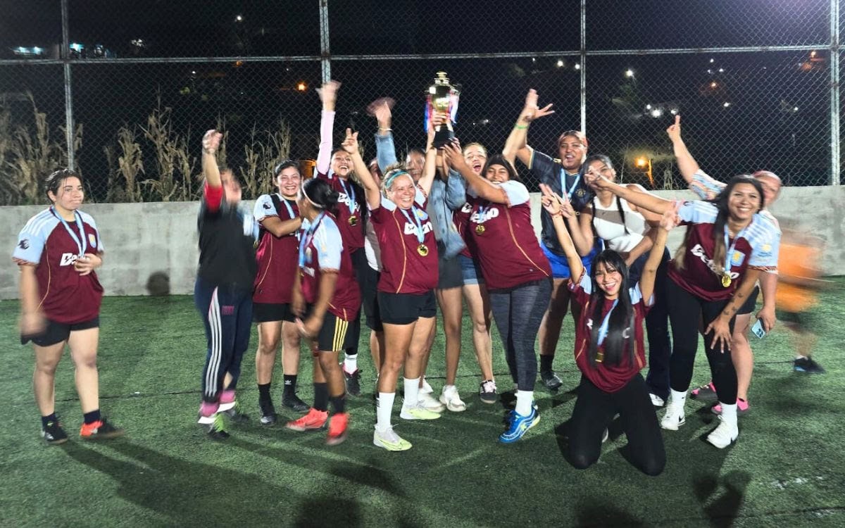 A candid group shot of the team celebrating a victory on the field.