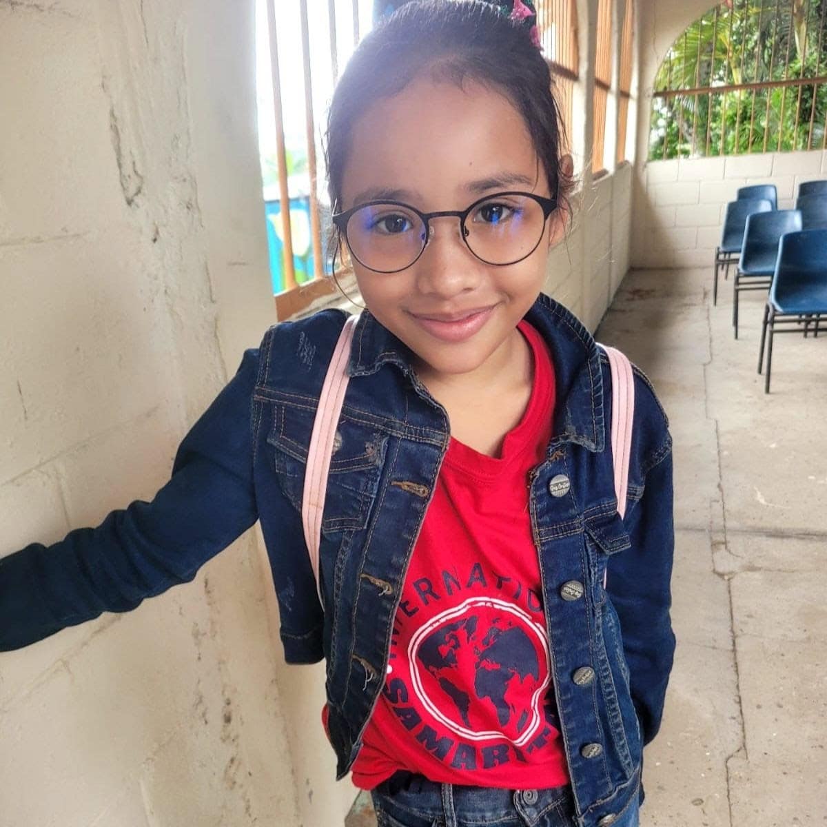 Image of child smiling outside of school