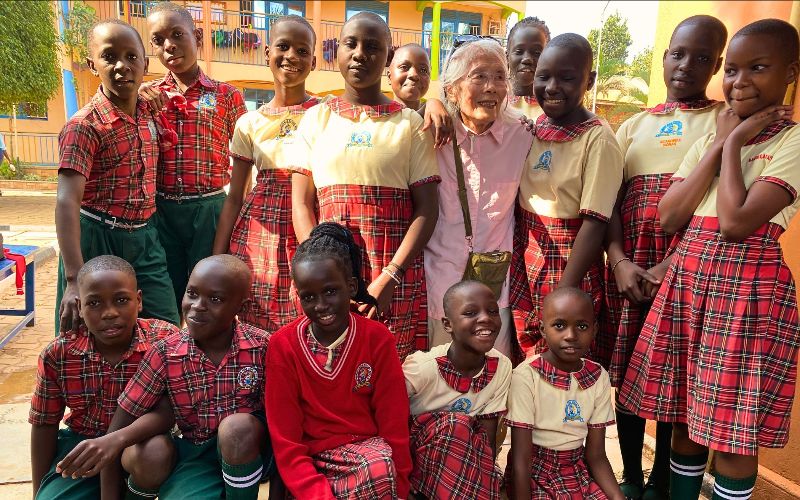 Pauline Beh and a group of scholars in Uganda.
