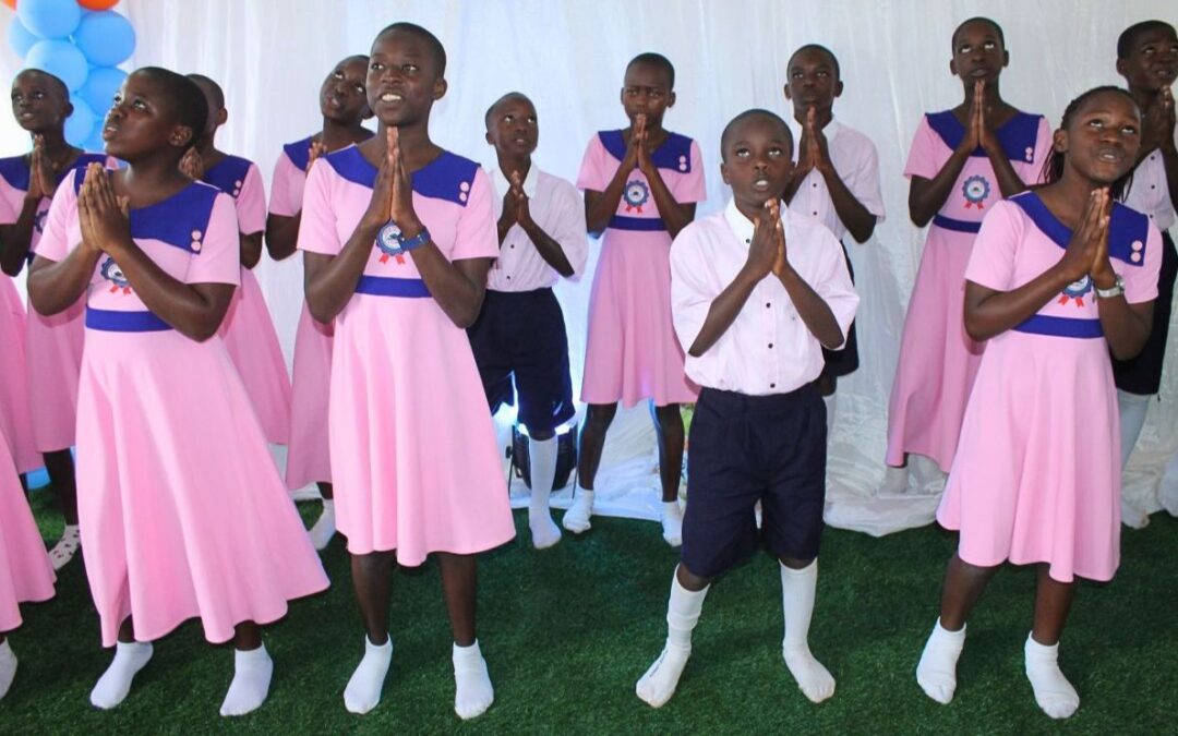 A group of Ugandan scholars pray during a performance.