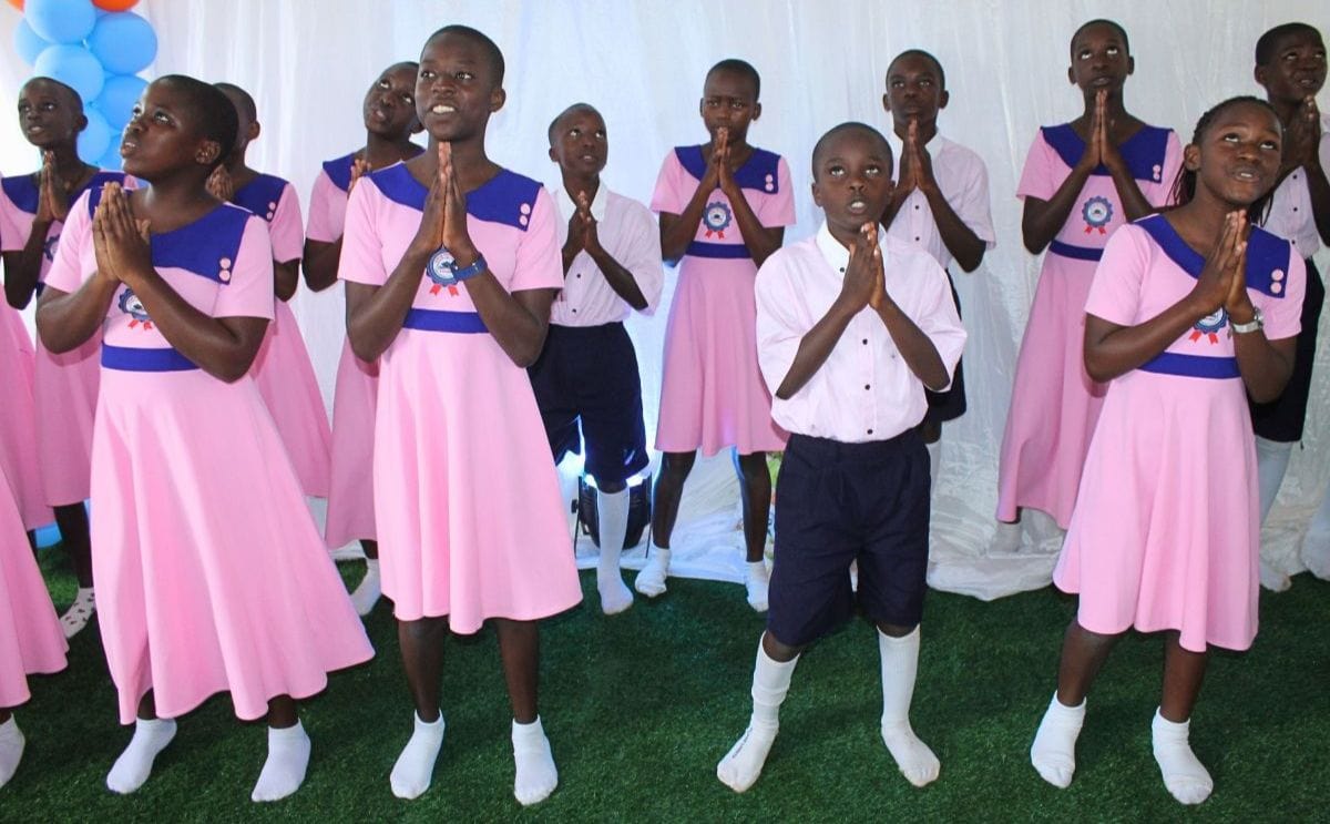 A group of Ugandan scholars pray during a performance.