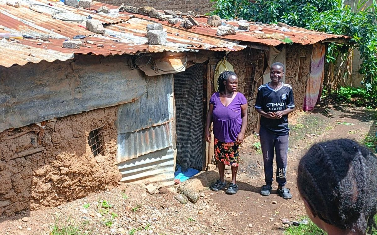 Alex and his mother outside their home.