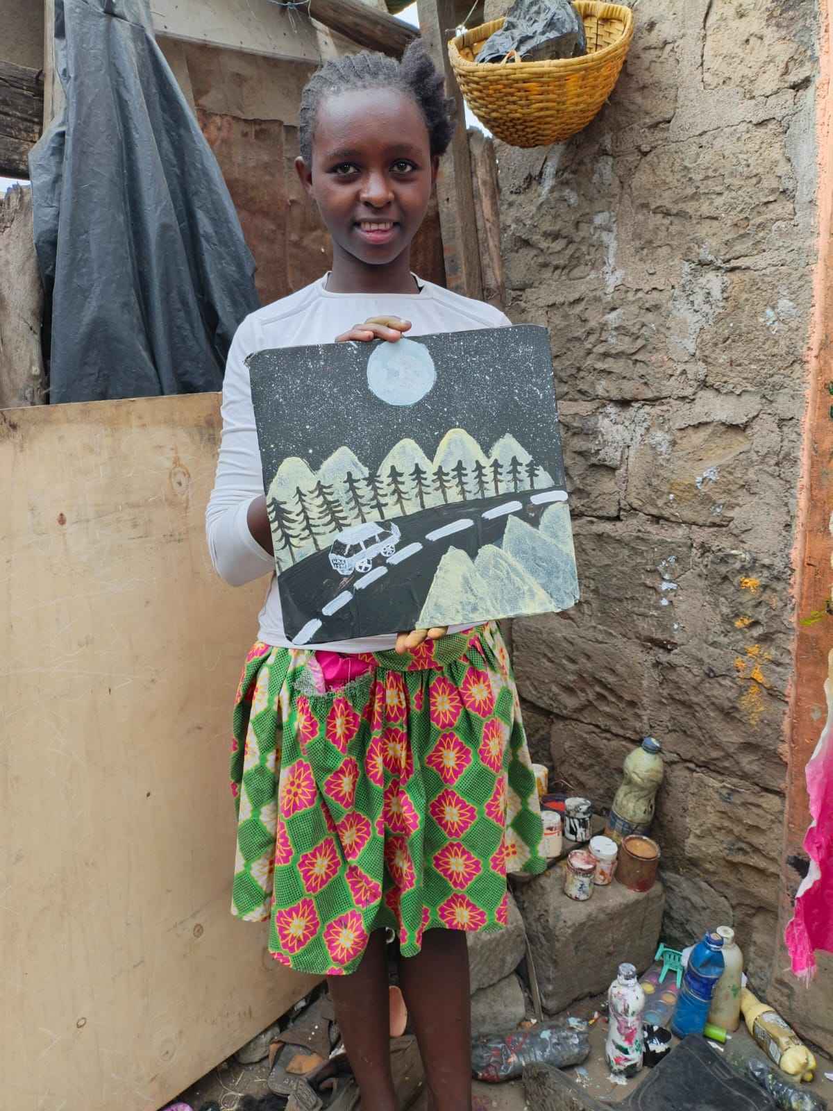 Martha with her art in her home.