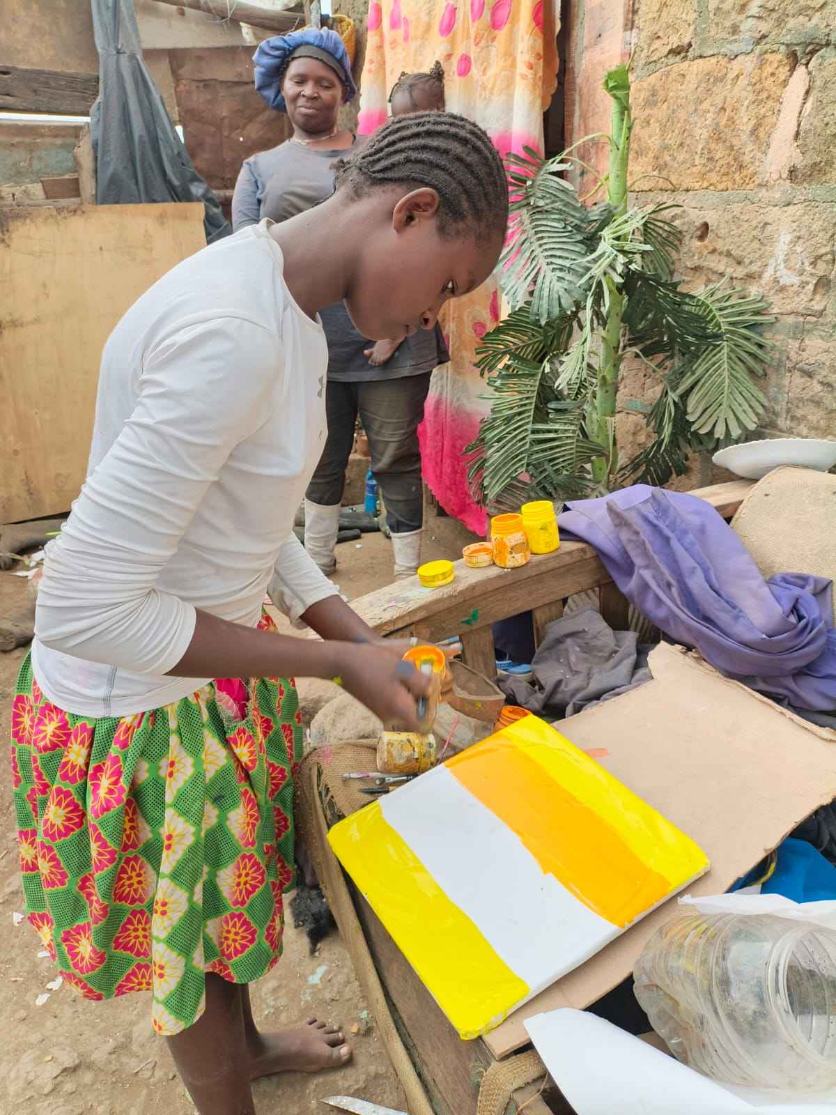 Martha with her canvas and paints at home.